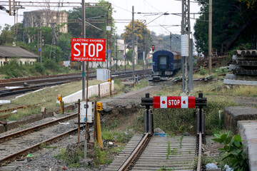 End of rail road near railways station  India with background of train coach passing