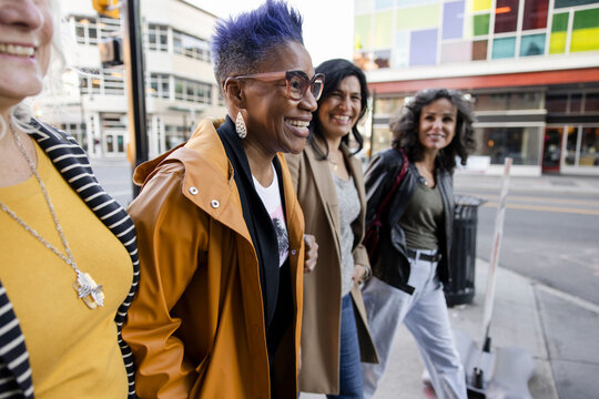 Happy Mature Women Friends On City Sidewalk