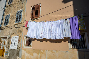 Laundry hanged on the rope to dry outside in the narrow and old streets of Rovinj, Croatia