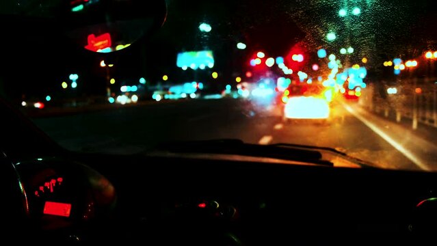 view from the windshield of the car. Moves at night along the highway, turns right after other cars.