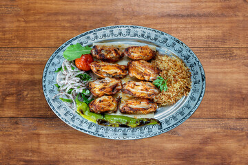 Grilled chicken wings with spices in on copper plate. middle eastern food. 
