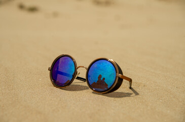 Fototapeta na wymiar Sunglasses on the sand