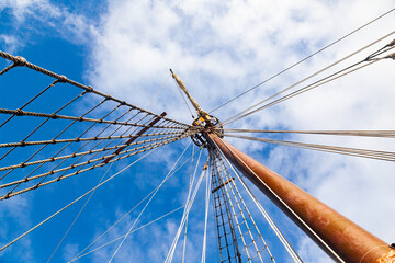 Mast with ropes and ladder on an old wooden ship, bottom view.