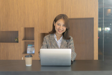 Portrait of a young beautiful Asian woman in a office room, concept image of Asian business woman, modern female executive, startup business woman, business leader woman.