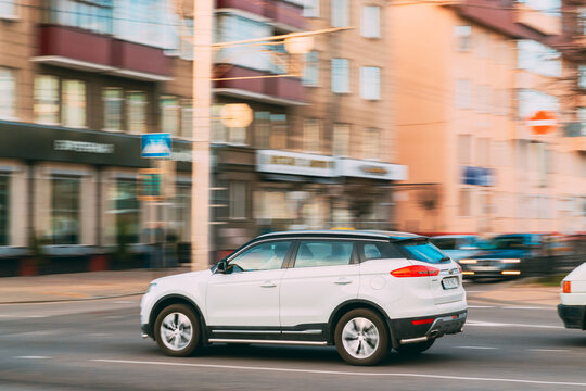 Gomel, Belarus - April 16, 2019: White Geely Boyue (Geely Atlas) Car Fast Rides City Street. Side View. The Geely Boyue Is A Compact Crossover Suv Produced By The Chinese Automaker Geely