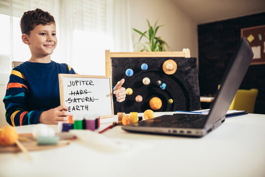 Kid presenting his science home project - the planets of our solar system. Distance learning online education.