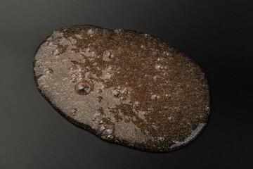 Coral transparent slime with bubbles inside on black background. Kids toy slime.