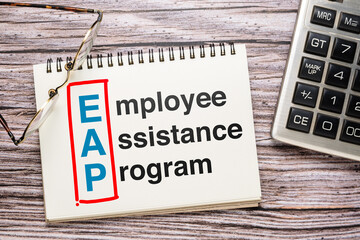 Employee Assistance Program or EAP text on opened notebook on the desk