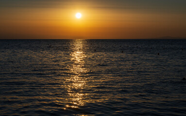 Tranquil scene of beautiful sea at sunset. Orange and yellow sunset on the sea. Aerial panoramic view of sunset over sea.