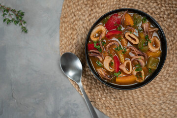 Stewed squid rings in tomato sauce for dinner. Top view.