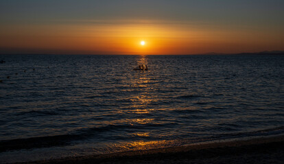 Obraz premium Tranquil scene of beautiful sea at sunset. Orange and yellow sunset on the sea. Aerial panoramic view of sunset over sea.