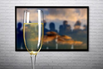 Online TV series and movies for Christmas holidays concept. glass of champagne