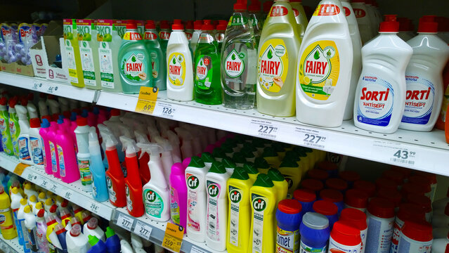 Supermarket. Retail industry. Shelves with Detergent, washing powder, soap powder, cleanser, plastic bottles with gel for dish washing and house cleaning. St. Petersburg, Russia - January 26, 2022.