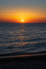 Obraz premium Tranquil scene of beautiful sea at sunset. Orange and yellow sunset on the sea. Aerial panoramic view of sunset over sea.