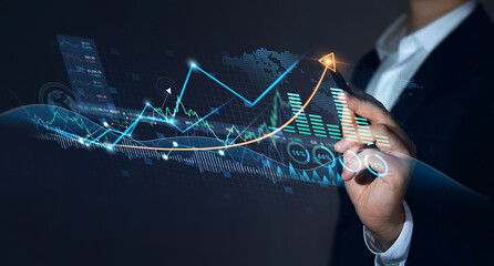 Stock market and analyzing sales data.Businessman draws growing virtual hologram of statistics,...