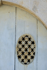 cast iron grate on an old door in Tavira, Algarve, Portugal