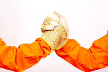 Teamwork gesture concept, partnership, builders in gloves greet each other with a handshake.