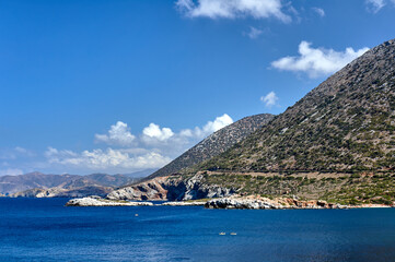 Fototapeta na wymiar Kayaking in a bay off the mountain coast of the island of Crete