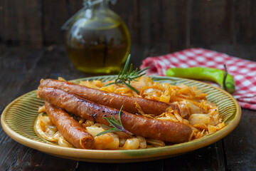 Traditional cooked sauerkraut with sausages and beer..Stewed sour cabbage with grilled sausages.
