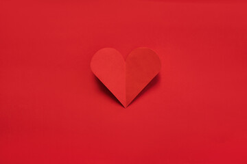 Valentines day paper heart on red background. View from above. Valentines Day Concept.
