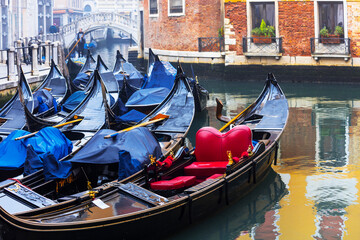 Venetian streets and canals. Scenery with traditional gondola boats. Venice, Italy