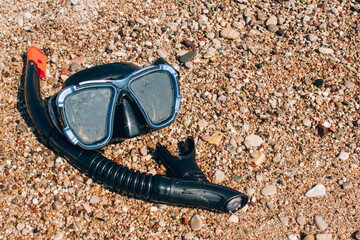 Diving concept, underwater dive mask on sea shore