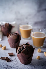 Chocolate cupcakes with dark chocolate slices and coffee drink