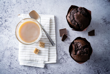 Chocolate cupcakes with dark chocolate slices and coffee drink