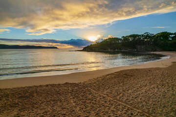 Aerial sunrise seascape with overcast sky and rain clouds