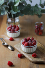 Italian dessert panna cotta with raspberries on wooden background.