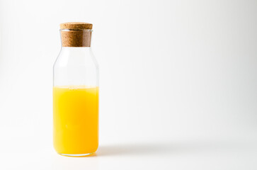 Orange juice glass bottle. Isolated on white background