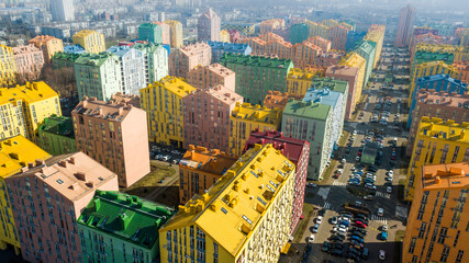 aerial view of colorful (red, green, blue, yellow) buildings on city street. drone shot