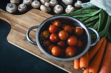 Vegetables on the table. Preparing healthy food: carrots, green beans, tomatoes and portobello mushrooms