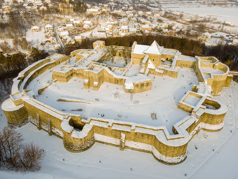 Birds eye view over the medieval stronghold of Suceava. Aerial photography of the medieval fortress from Suceava, Romania shot from a drone in winter season. 