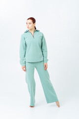 An Asian woman with red hair is standing barefoot in a turquoise fleece pajama suit. Zipper on...