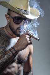 Sexy man smoking cigar. Brutal man with cigar and serious face of handsome male model, concept of...