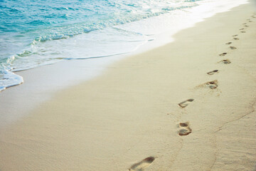 Human footprints on a sandy beach.