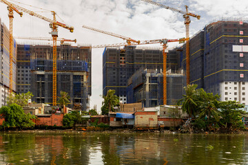 Fototapeta na wymiar Construction site with cranes in Ho-Chi-Minh-City