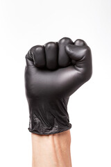 Raised fist in black rubber glove isolated on white background. Clenched fist as a symbol of...