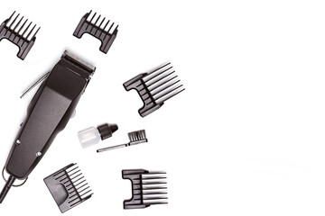 Professional hair clipper with set of nozzles of different sizes isolated on white background. Top view. Copy space for text