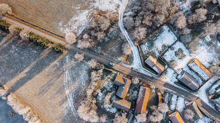 Aerial view of small village in winter.Top view of traditional housing estate in Czech.Looking straight down with satellite image style.Houses from above, real estate concept.Country road urban scene