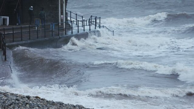 Large wave crashing on shoreline in slow motion