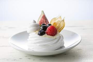 Sweet dessert, Pavlov's cake with butter cream and raspberry, blueberry, fig.