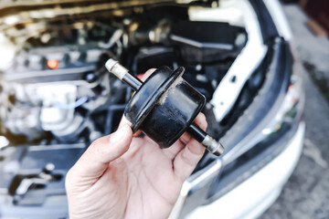 Old gear oil filter of the car transmission system on the mechanic hand