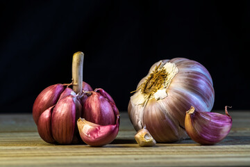 Garlic Cloves and Bulb on the wooden table and  dark background in Brazil. Copy space.