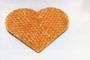 Heart shaped Dutch stroopwafel waffle on white