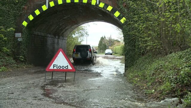 Floods In May 2012 Southern UK With Sign And Railway Bridge