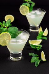 Mojito cocktails garnished with lime and mint