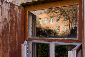 broken glass in the window of an old abandoned house, photo from outside the house