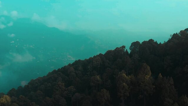 Aerial view of green hills surrounded by trees in Murree, Pakistan